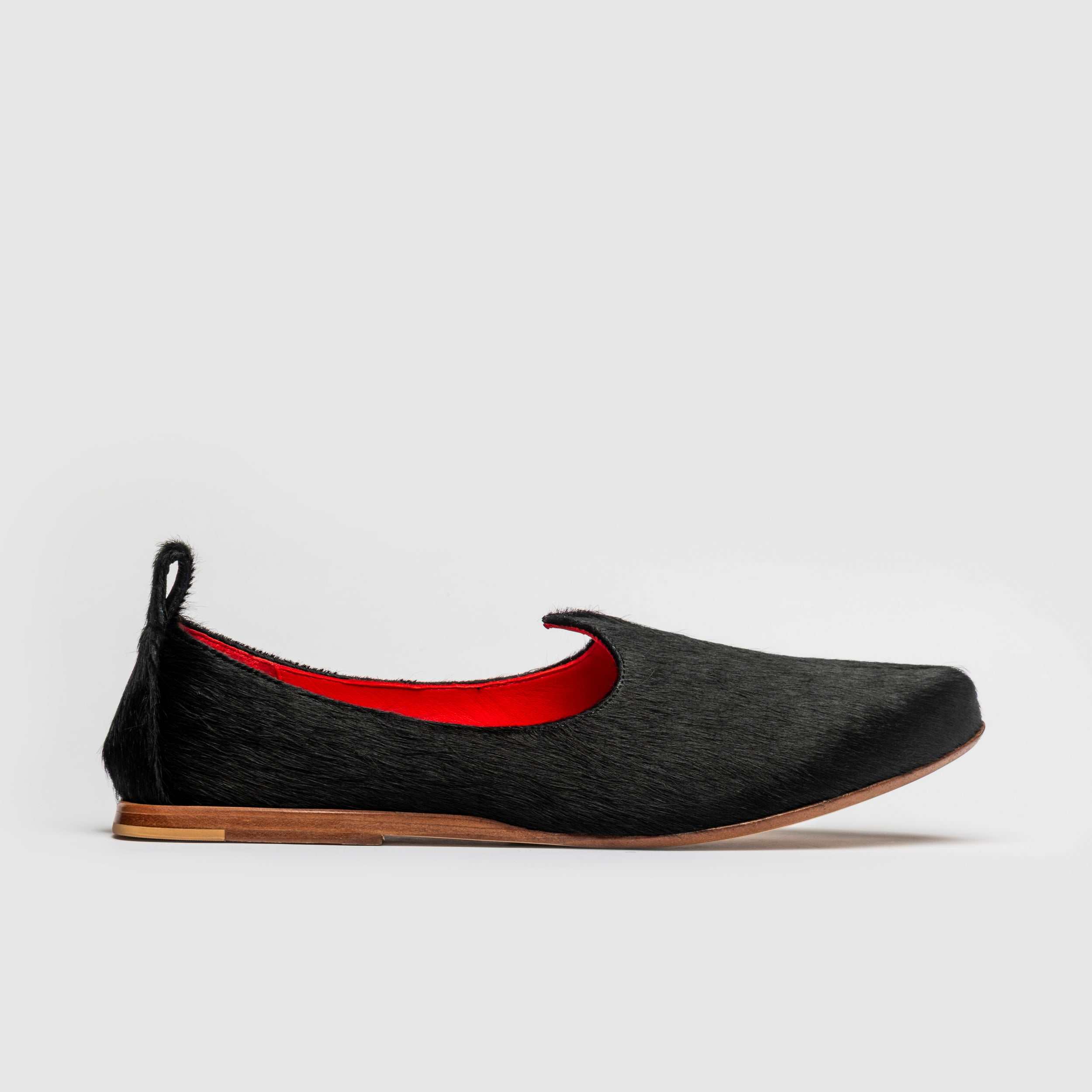 Men's hair styled on handcrafted Indian-inspired leather mojri shoes