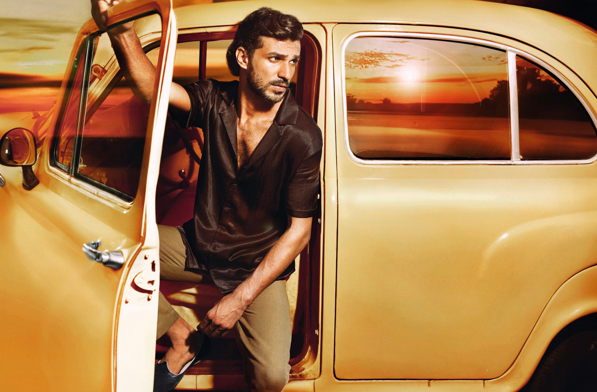 Model in an vintage Ambassador car from India. Wearing a JOCO shirt made in Cupro fabric. 